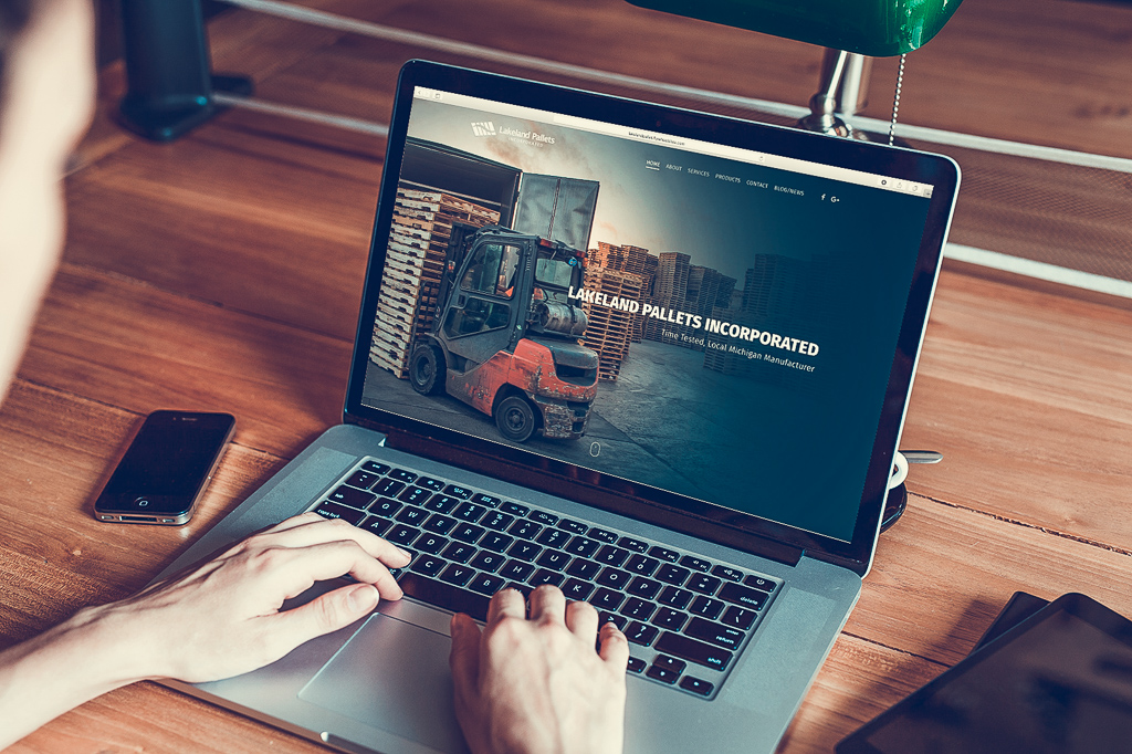 A person looking at the Lakeland Pallets website on a laptop