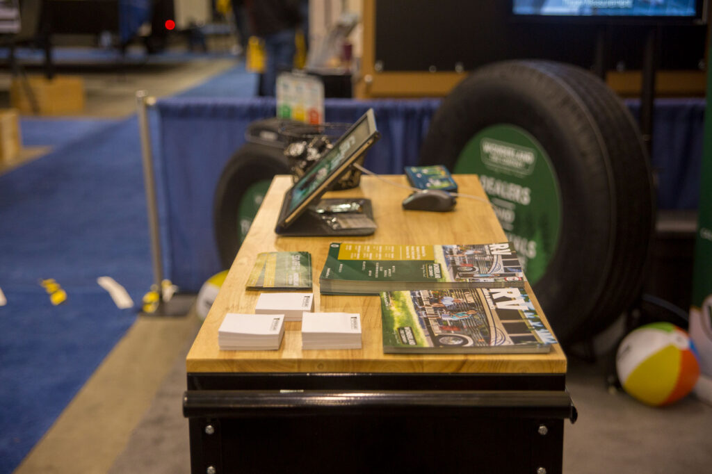 Printed materials on the table in the Wonderland Tire booth at a trade show